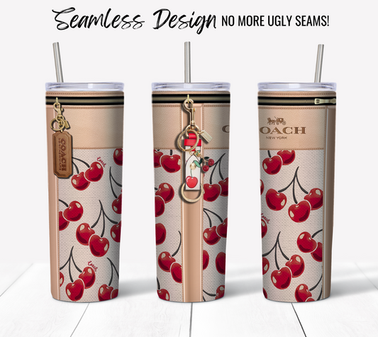 Three tall, slim NY Coach tumblers with a seamless cherry print design. The tumblers feature a beige background with red cherries and metallic lids. The front tumbler showcases two keychains – one with a leather tag and another with a cherry charm. Text above reads "20 oz Sublimation Tumbler Wrap - No More Ugly Seams!