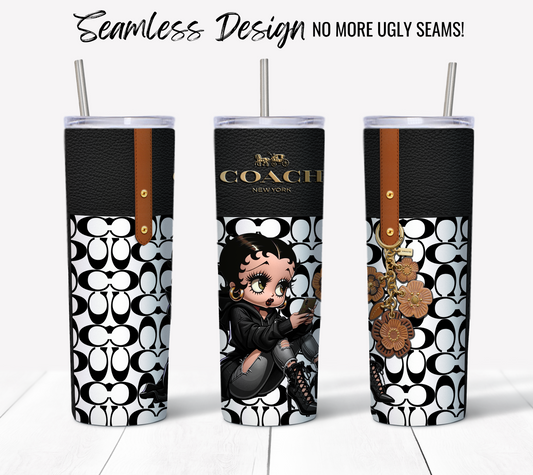 Three NYC Coach Black and White Monogram 20 oz Sublimation Tumblers featuring a seamless design. The center tumbler has an illustration of Betty Boop sitting with a drink. The Coach logo is visible along with decorative elements like floral charms and leather accents near the lids and body. Text reads, "Seamless Design - No More Ugly Seams!