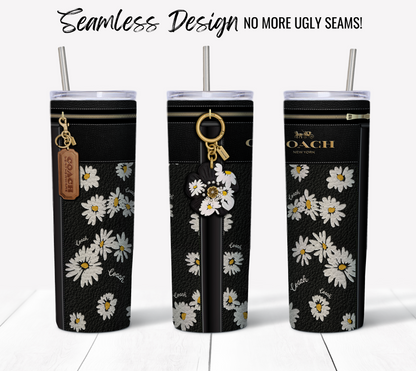 Three tall black tumblers with silver straws, adorned with white daisy patterns, are shown. Each tumbler features a brown Coach tag, with one also having a daisy keychain. Crafted using sublimation printing for a seamless design—NO MORE UGLY SEAMS! Ideal for your NY Coach Daisy Leather Texture 20 oz Sublimation Tumbler Wrap.